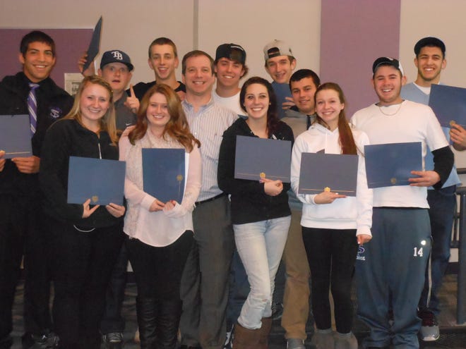 Cambridge Savings Bank Financial Education Program Manager Evan Diamond with Shawsheen Valley Technical High School seniors who received "Certificates of Graduation" from the CSBsmart Financial Education Program.