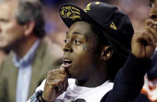 FILE - In this Nov. 13, 2012 file photo Entertainer Lil' Wayne attends the Duke-Kentucky NCAA college basketball game at the Georgia Dome in Atlanta. Lil Wayne says he's an epileptic and has had seizures for years. In an interview with Los Angeles-based radio station Power 106 on Thursday, March 28, 2013, the 30-year-old rapper said epilepsy caused his most recent health scare earlier this month, when he was rushed to a hospital. Wayne said he had three back-to-back seizures. (AP Photo/Dave Martin)
