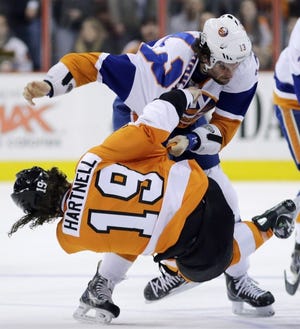 Philadelphia's Scott Hartnell falls to the ice during a fight with the Islanders' Colin McDonald during Thursday's game in Philadelphia.