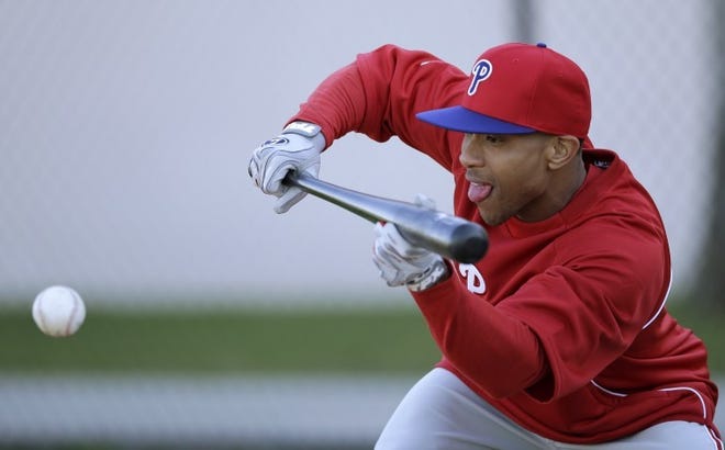 Philadelphia Phillies Ben Revere lays down a bunt during a workout at baseball spring training, Sunday, Feb. 17, 2013, in Clearwater, Fla. (AP Photo/Matt Slocum)