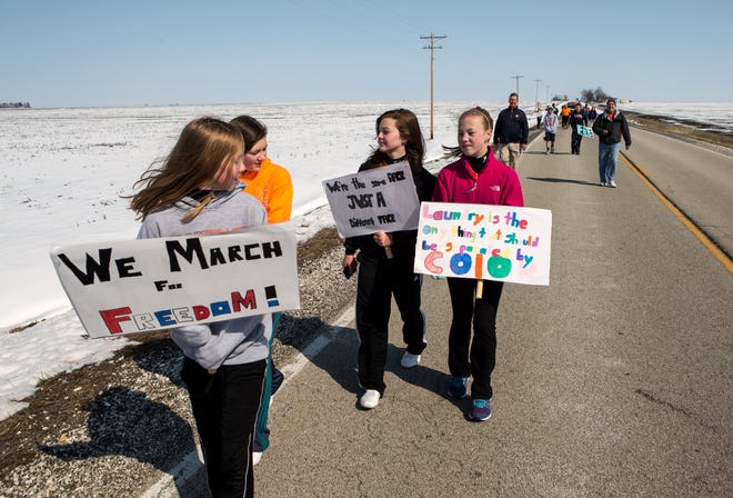 From left, Emily Jones, 12, left, Sharon Smith, 12, Victoria Menge, 13, and Megan Crow, 12, make the nine-mile march from Alexander to Franklin along with their fellow Franklin Junior High seventh- and eighth-graders Thursday. The march was was to give the students an idea of what it was like during Martin Luther King's 1968 "March on Memphis." Justin L. Fowler/The State Journal-Register