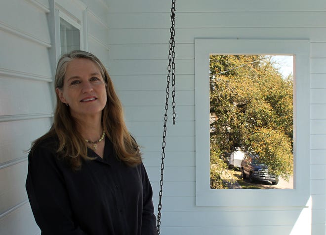 Amy Andrews-Harrell, a Richmond resident who has come on board as costumer for the planned Bayard Wootten movie to be shot locally, has some roots in New Bern. Here she stands on the second floor porch of pioneer photographer Wootten’s home.