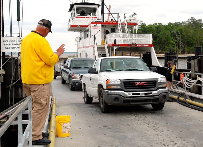 Drivers exit the Cherry Branch-Minnesott Beach ferry after a trip across the Neuse River.