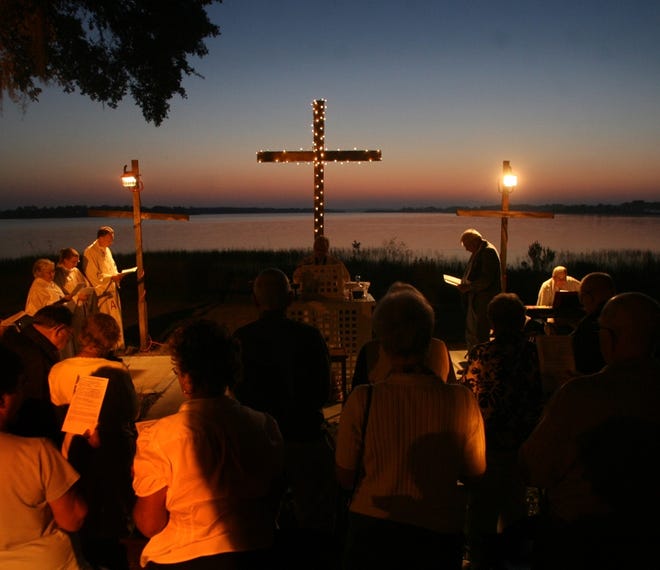 People stand for a part of the 2011 Easter Sunrise Service at Saint John Lutheran Church in Summerfield. This year, the church will hold its sunrise service at 6:15 a.m. on Sunday.