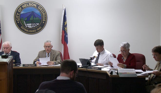 In a this image made from video, the Nelson, Ga. City Council meets to vote on a mandatory gun ownership ordinance for all heads-of-household, Monday, April 1, 2013. From left are council member Jackie Jarrett, Mayor Mike Haviland, council member Duane Cronic, council member Edith Portillo, and city attorney Jeff Rusbridge. Council members in Nelson, a city of about 1,300 residents that's located 50 miles north of Atlanta, voted unanimously to approve the Family Protection Ordinance. The measure requires every head of household to own a gun and ammunition to "provide for the emergency management of the city" and to "provide for and protect the safety, security and general welfare of the city and its inhabitants." (AP Photo/Johnny Clark)