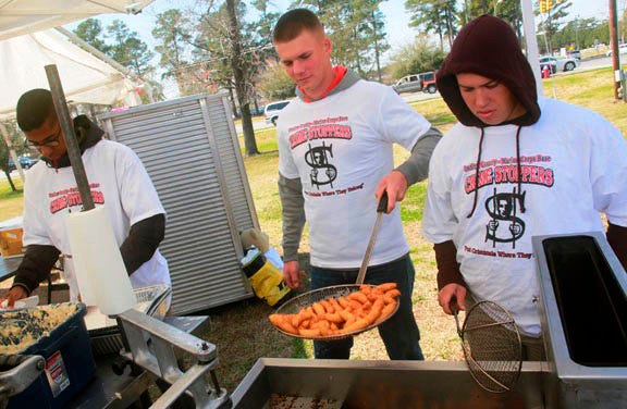 Marines from Camp Johnson help during last week’s Crime Stoppers annual barbecue fundraiser, the most successful in the organization’s 14-year history.