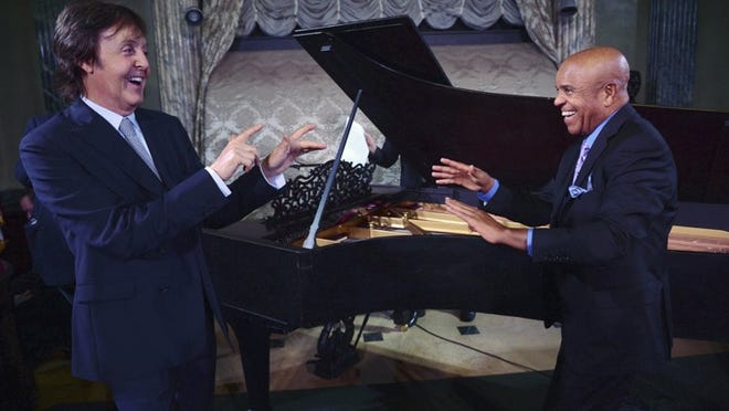 In this Sept. 18, 2012 photo, Paul McCartney, left, and Berry Gordy stand in front of a newly restored 1877 Steinway grand piano during a benefit at the Motown Museum at Steinway Hall in New York. The piano, used by Motown greats during the label’s heyday, was restored with an assist by McCartney. It has now moved home to Detroit.