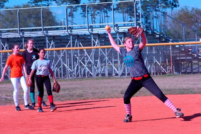 Destin’s Gabby Nix makes the throw to first during a drill Monday afternoon at Destin Middle School.
