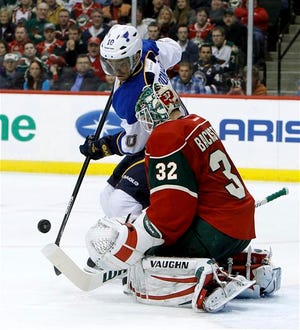 Minnesota Wild goalie Niklas Backstrom (32) deflects a shot by St. Louis Blues center Andy McDonald (10) during the second period of an NHL hockey game in St. Paul, Minn., Monday, April 1, 2013. (AP Photo/Ann Heisenfelt)