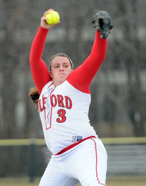 Milford's Shannon Smith fires a pitch before a rain storm shut down the Scarlet Hawks in their season opener against Shrewsbury on Monday.