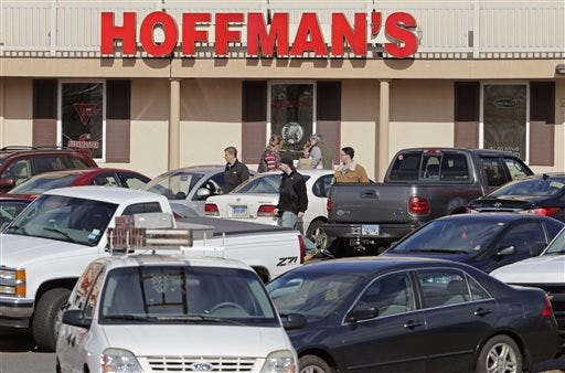 Customers are packing gun stores around Connecticut following the unveiling of new gun-control legislation, which could take effect as soon as Wednesday evening. Cars jam the parking lot Tuesday as shoppers leave Hoffman's Gun Center with their purchases in Newington, Conn.