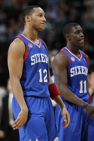 Sixers guard Evan Turner (12) reacts after missing two free throws in the closing seconds of the fourth quarter during a 101-100 loss to the Nuggets on March 21. Jrue Holiday is at right.