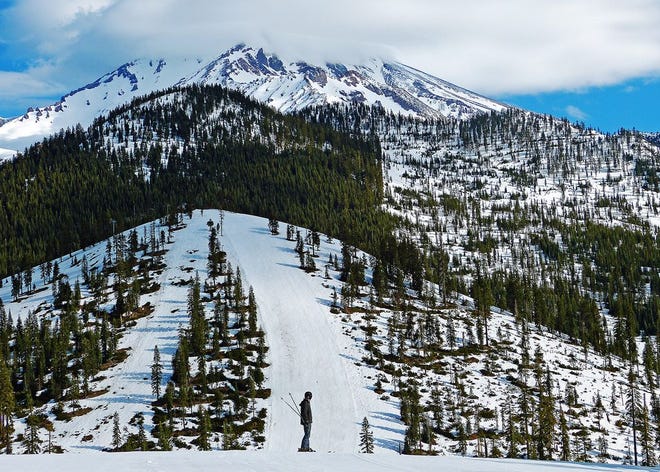 A skier contemplates a last run on the Mount Shasta Ski Park’s closing day from the magnificent view at the top of the Saddle run off the Douglas lift. Photo by Paul Boerger