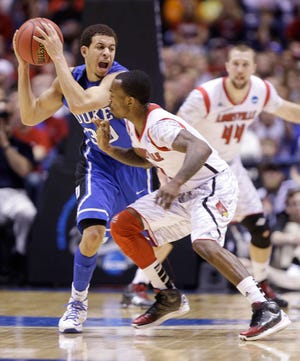 Duke's Seth Curry, right, is swarmed by Louisville's Russ Smith during Sunday's Elite Eight game.