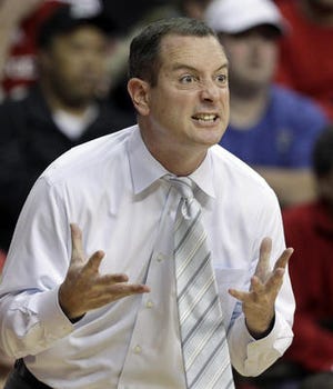 FILE - In this Jan. 7, 2012, file photo, Rutgers coach Mike Rice reacts to play during an NCAA college basketball game against Connecticut in Piscataway, N.J. The airing Tuesday, April 2, 2013, of a videotape of Rice using gay slurs, shoving and grabbing his players and throwing balls at them in practice over the past three seasons has Rutgers athletic director Tim Pernetti reconsidering his decision not to fire the coach. Pernetti was given a copy of the video in late November by a disgruntled former employee, and he suspended Rice for three games, fined him $50,000 and made him undergo anger management classes for inappropriate behavior after investigating it. (AP Photo/Rich Schultz, File)(AP Photo/Mel Evans, File)