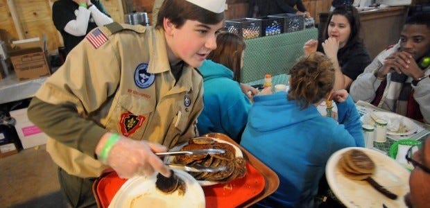 Boy Scout Shawn Galbreath of Patterson Township helps with the pancakes during the 2012 Beaver County Maple Syrup Festival at Bradys Run Park.