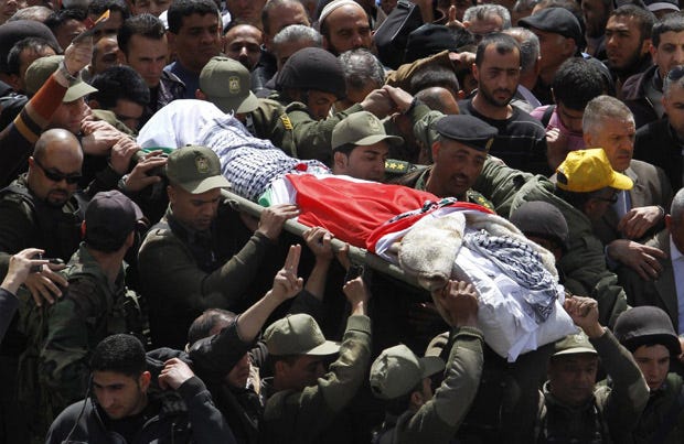 Palestinian security forces carry the body of Maysara Abu Hamdiyeh during his funeral in the West Bank city of Hebron. The 64-year-old man was serving a life sentence for a 2002 foiled bombing of a busy Jerusalem cafe. After Abu Hamdiyeh died, the Palestinians blamed Israel for the death, saying he was not given proper medical care.