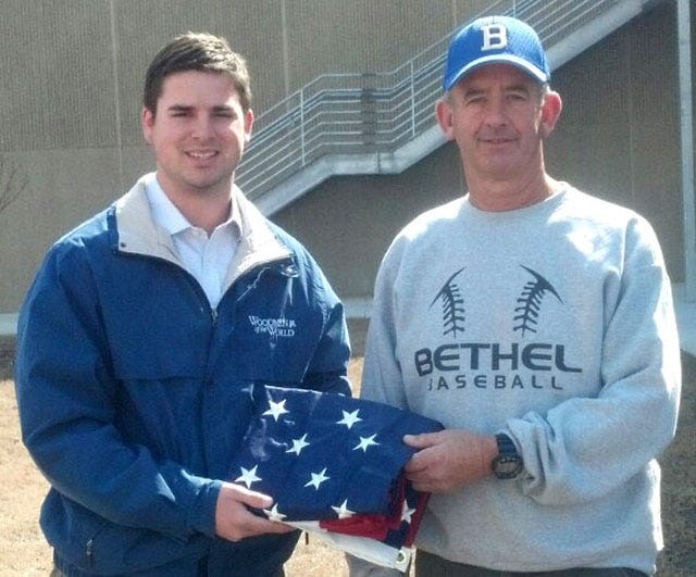 John Walters, left, a field representative with Woodmen of the World Life Insurance Society, presents an American flag to Bethel Christian Academy’s baseball coach, Kenny Sutton.