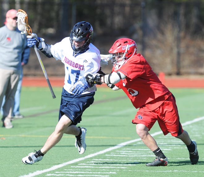 Pembroke's Tom Waterfield, left, is checked by Bridgewater-Raynham's Matt Cicalis during a lacrosse game on Wednesday, April, 3, 2013, at Pembroke High School.