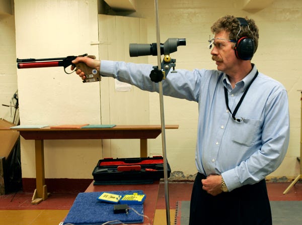 In this Feb. 21, 2007 file photo, Bruce Martindale takes aim as he competes in a weekly air gun league in Troy, N.Y. Martindale, who normally uses a .22-caliber, has cut back on practice because ammunition is in short supply. (Mike Groll | Associated Press | File)