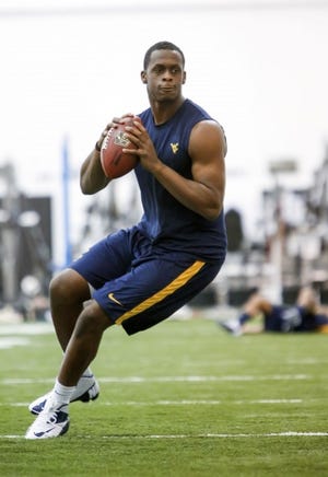 Will West Virginia quarterback Geno Smith pull on an Eagles jersey Thursday night when the NFL Draft begins?