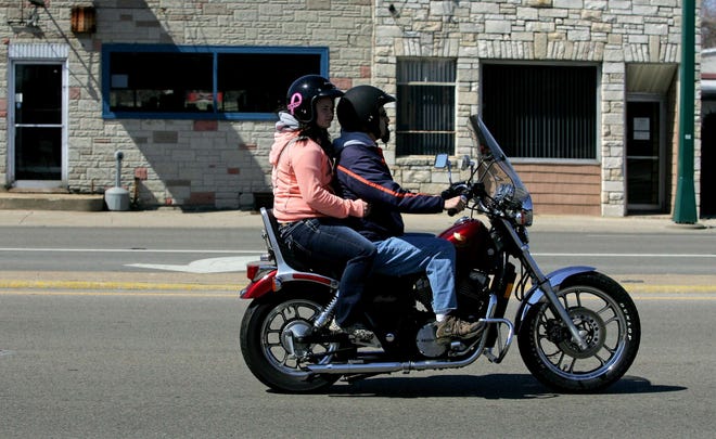 A motorcyclist and his passenger ride Thursday, April 4, 2013, along Illinois 251 in Loves Park. The Illinois Department of Transportation has kicked off its “Gear Up – Ride Smart” campaign to promote safe motorcycle riding. Nineteen states plus the District of Columbia require all motorcyclists to wear helmets; 28 states require some motorcyclists to wear helmets; 3 states — Illinois, Iowa and New Hampshire — have no helmet laws.