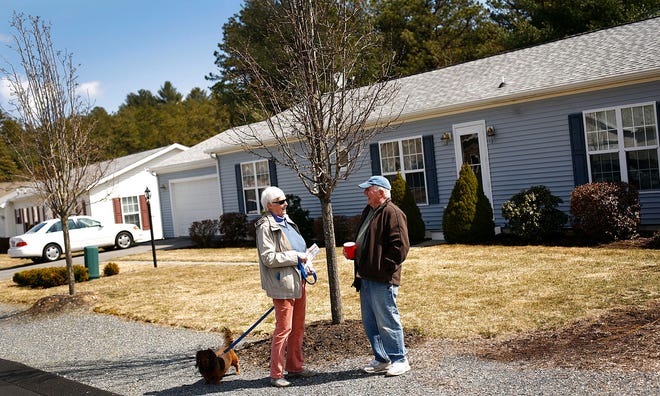 West Woods Village in West Plymouth, a senior community of manufactured homes which was bought from the land owner by residents last year.Joanie McKeaggan (CQ) talks with neighbor Dick Bennet while she was out walking her dog Rudy. Joanie moved into the community 2 years ago, Dick in 2006.