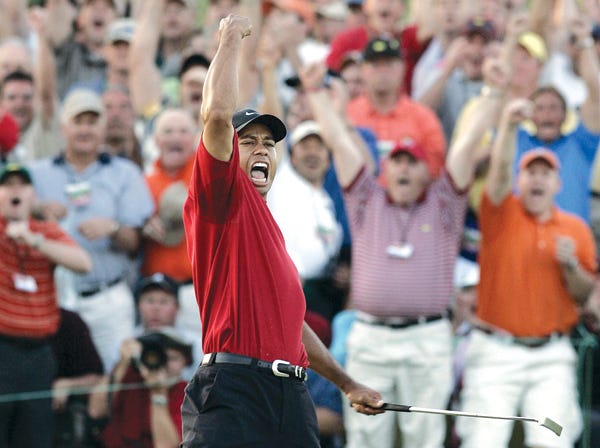 Tiger Woods celebrates winning the 2005 Masters. (Elise Amendola | Associated Press)