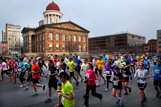Runners make their way south on Sixth St. past the Old State Capitol shortly after the start of the race early Saturday morning. The 49th annual Lincoln Presidential Half-Marathon took place on Saturday, April 6, 2013 along a 13.1 mile route starting downtown and finished on the campus of St. John's Hospital. 1686 runners from 27 states and Germany competed in the race, which had athletes starting at the Abraham Lincoln Presidential Library and Museum and taking in sites along the course including the Old State Capitol, Lincoln's Home, Lincoln's Tomb and the Thomas Rees Memorial Carillon in Washington Park.