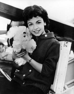 In this March 24, 1959, file photo, Walt Disney studio's new star, 16-year-old Annette Funicello, poses with her Shaggy Dog doll at Idlewild Airport in New York.