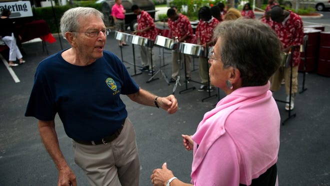 South End residents Andre (ACCENT MARK ON E) and Jan Volaffi dance to music from the Lake Worth High School's Steel Band at an end of season barbecue hosted at the BankUnited building on Thursday.
