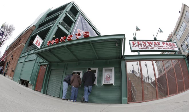 In this image taken with a fisheye lens, fans stand at the ticket windows at Fenway Park in Boston.