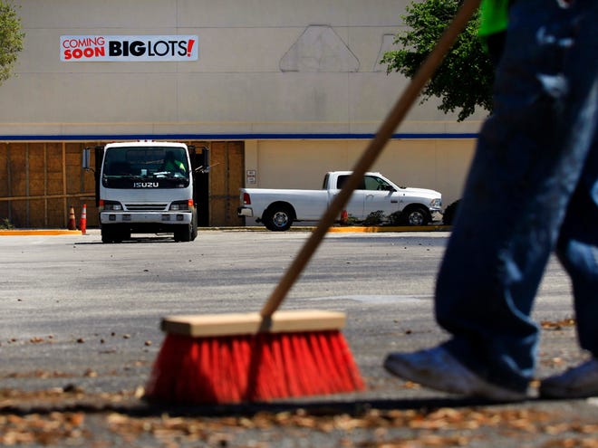 Dorian Powell sweeps the parking lot of the old Albertson's at 2323 NW 13th St. Monday in preparation for the coming of a new Big Lots location in Gainesville.