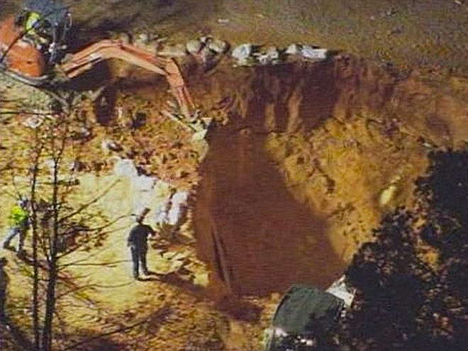 In this image made from video and provided by WSOC-TV Charlotte, authorities work to rescue two children at a construction site Sunday in Stanley, N.C. (AP Photo/WSOC TV)