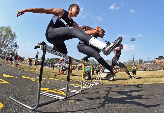 Brittany Randolph / The Star
Shelby's Ralph Jolly, left, sails over a hurdle in the Cleveland County Championship Meet at Crest's Sid Bryson Stadium Tuesday.