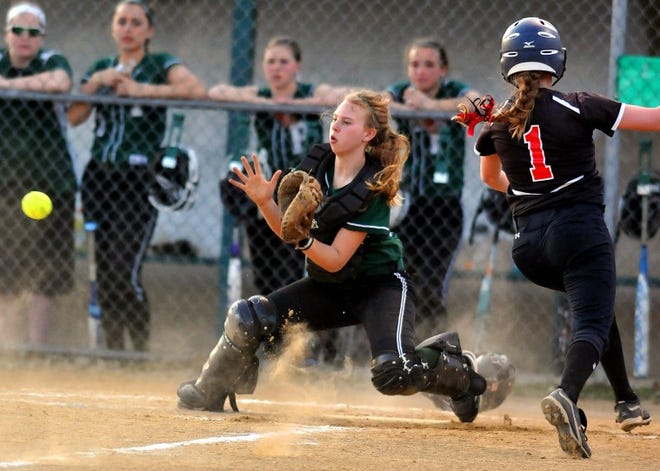 Pennridge's Liv Campbell (33) waits for the throw to home as Hatboro Horsham's Heather Lutz (1) crosses the plate during Tuesday's game at B. Earl Druckenmiller Park in Sellersville. Lutz later hit a grand slam home run as the Hatters won in 10 innings, 11-8.