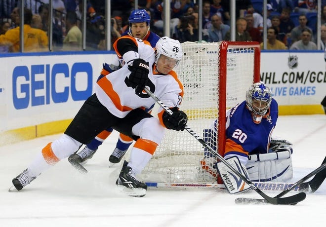 Islanders goalie Evgeni Nabokov stops a wraparound scoring attempt by Flyers left wing Ruslan Fedotenko during Tuesday's game at the Nassau Coliseum in Uniondale, N.Y.
