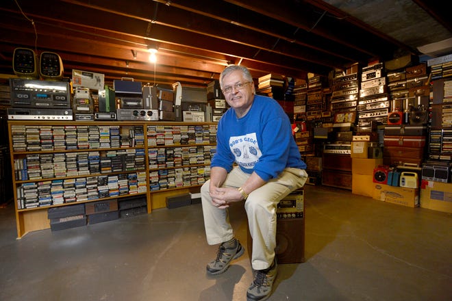 Bob Hiemenz rests Tuesday on an eight-track karaoke machine in the basement of his Peoria home where he has 20,000 eight-track tapes and 200 players, with another 10,000 tapes in his garage and 40,000 more tapes in Flora, his former home.