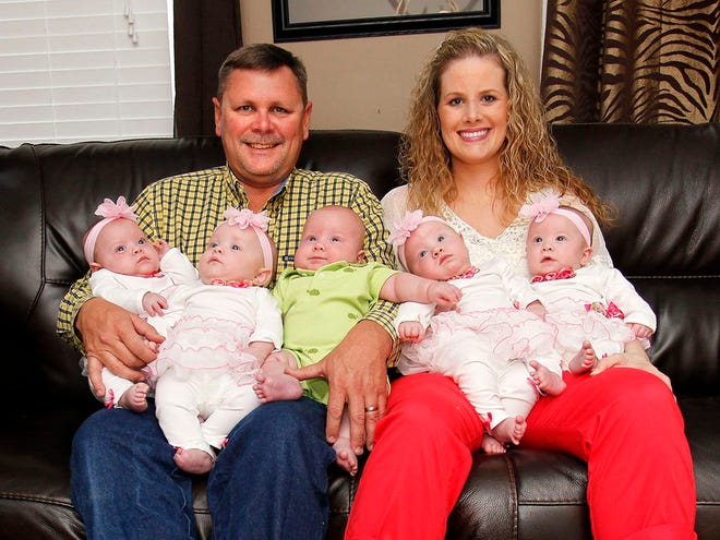 Kelley, left, and Stacy Dyal with their quintuplets, from left to right, Kyleigh, Kamryn, Kaleb, Kyndall and Kayleigh at their home on the Dyal Family Farm in Brooker Monday April 8, 2013. Stacy gave birth to premie quintuplets Nov. 15, 2012 and the five are reaching their 5 month birthdays and growing stronger every day.