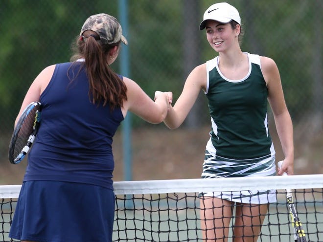 Forest's Alice Cannon, right, shakes hands with Land O'Lakes Cori Arndt, left, after Cannon won the regional playoff match at Coehadjoe Park in Ocala on Tuesday.