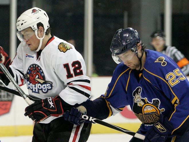 Peoria's Tyson Strachan hits Rockford's Jack Skille as he tries to get a shot on goal during their game at the MetroCentre in Rockford on Sunday, Nov. 16, 2008.