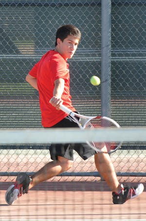 Oak Hills' Misseal Vasquez hits a return during a Mojave River League match against Sultana on Wednesday. Vasquez swept his sets as the Bulldogs won 12-6.