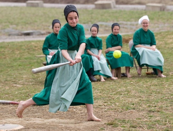Amish girls play softball at a picnic in Bergholz, Ohio held as a farewell for members of the religious group scheduled to be imprisoned on hate-crime convictions.