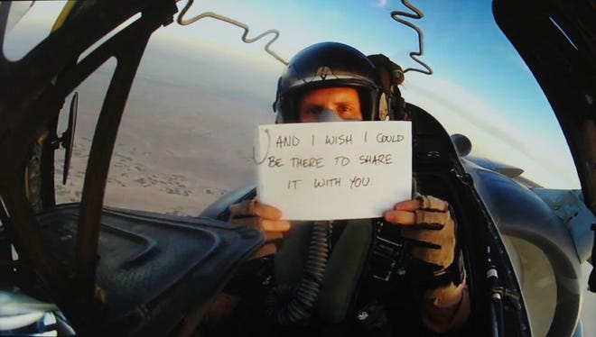 In this still image taken from a video, Marine Corps Capt. Matthew Krivohlavy, of VMA-231 at Cherry Point, sends a wedding message to his brother in Texas from the cockpit of his AV-8B Harrier.