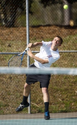 Jacksonville junior Christian Pullicino serves in his No. 1 singles match against White Oak’s Mason Russell on Wednesday at the Jacksonville Country Club. Pullicino rallied from a 4-6, 1-4 deficit to win on a third-set tiebreaker and help lead the Cardinals to a 7-2 win over their rivals.