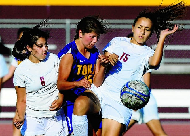 Tokay's Jessica Sanchez goes for the ball between Edison's Dehicy Munguia, left, and Rosario Perez during the first half Wednesday at Edison. Sanchez scored three goals in the second half to help give the Tigers a 3-0 victory.