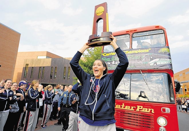 Connecticut's Stefanie Dolson carries the trophy during a parade through campus honoring the team's win in the women's NCAA Final Four college basketball championship in Storrs, Conn., Wednesday, April 10, 2013. (AP Photo/Jessica Hill)