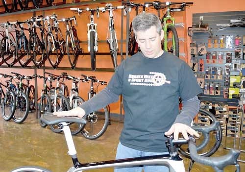 Photo by Jessica Masulli Reyes/New Jersey Herald Jason Ziegler, the owner of Sussex Bike and Sport Shop, shows a bicycle at the new Andover Township location on Thursday.
