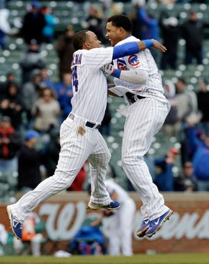Chicago Cubs' Starlin Castro, right, celebrates with teammate Luis Valbuena after hitting a game-winning double against the San Francisco Giants during the ninth inning of a baseball game in Chicago, Friday, April 12, 2013. The Cubs won 4-3. (AP Photo/Nam Y. Huh)
