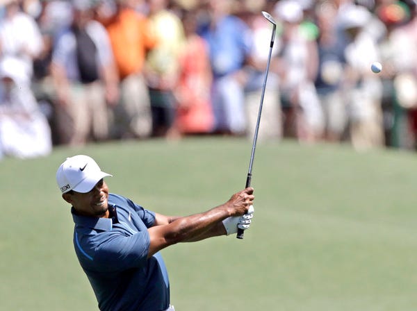Tiger Woods hits on the eighth hole at the Masters in Augusta, Ga., on Saturday. (David Goldman | Associated Press)